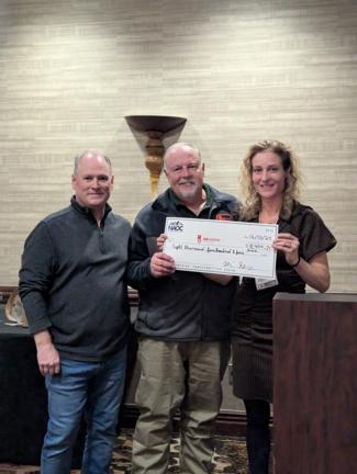 Image of President Ivy Harvey and Board of Director Shawn Corcoran presenting a check to the EOD Warrior Foundation Representative Greg Mittelman.